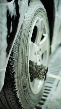 Washing a car wheel with a brush by hand