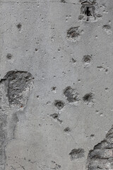 Old concrete wall with punched holes