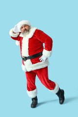 Dancing Santa Claus on blue background