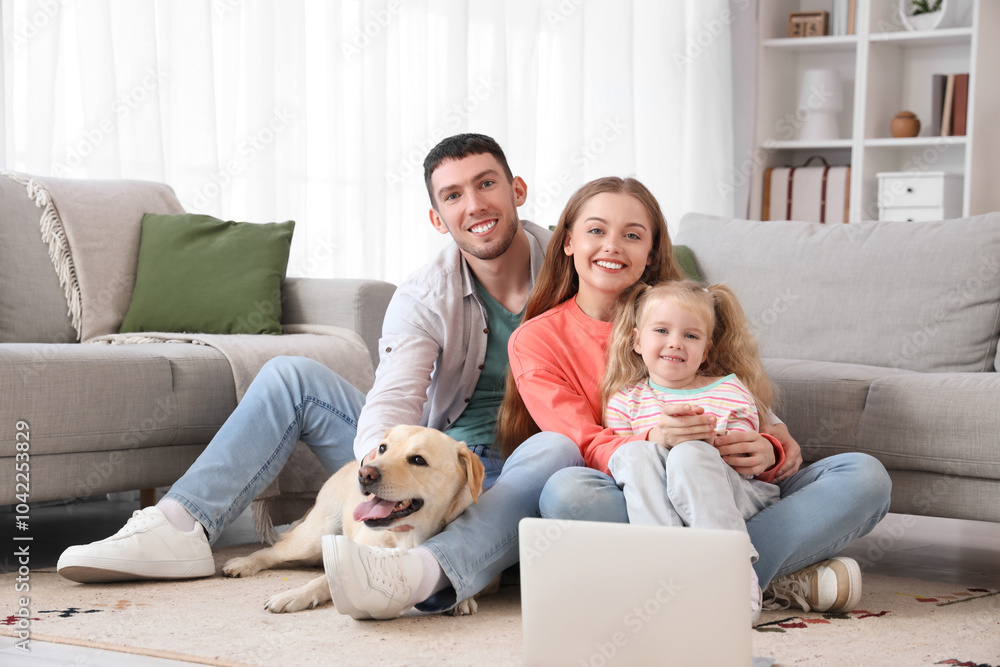 Poster Happy family with Labrador dog and laptop at home