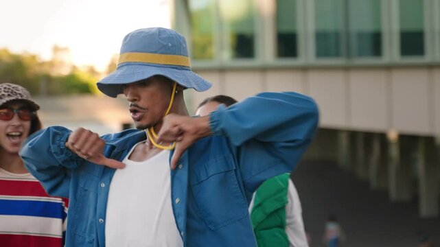 African American man dancing freestyle street dance in the city with trendy gang