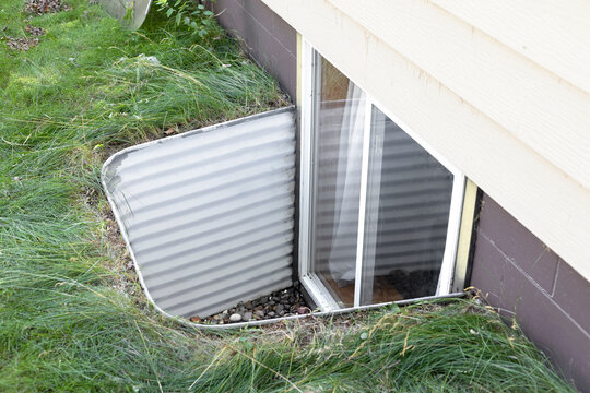 Exterior view of an egress window system. Egress window well installed in a basement.