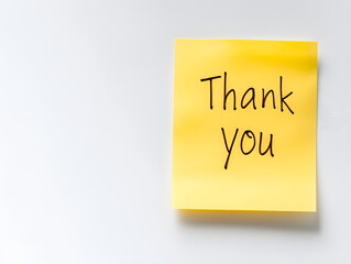 A yellow sticky note with the words "Thank You" written on it in black marker, isolated on a white background. Good for saying thanks and goodbye.
