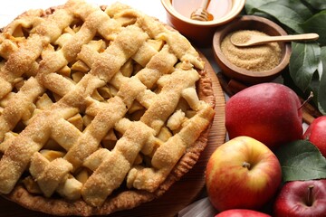 Tasty homemade apple pie and ingredients on table, closeup