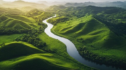 Lush green hills surround a winding river beneath a cloudy sky in a serene landscape during the early morning
