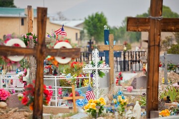 A vibrant Southwestern cemetery with crosses and flowers in Rancho de Taos, New Mexico, USA.