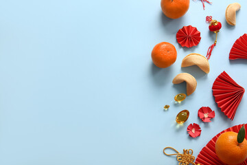 Chinese symbols with mandarins and fortune cookies on blue background. New Year celebration