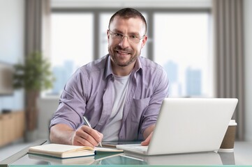 Fototapeta premium Happy handsome entrepreneur man work on laptop at office
