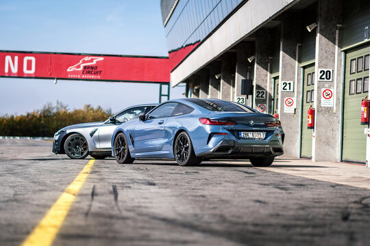 Blue BMW M sports car outside at the pits of the racing circuit in Brno. German fast car, rear view.