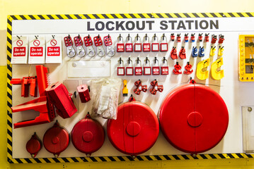 A close-up of a 'lockout station' displaying safety equipment used to securely lock out valves and...