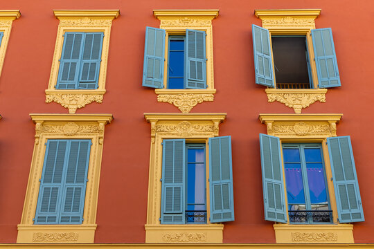 historic house with a red facade and shuttered windows in the city of Nice, Provence