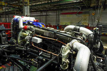 Truck production line. Workshop production of Heavy duty trucks. Trucks Manufacture. Assembly line of truck factory. Heavy duty truck plant. Frame, Wheel chassis, air suspension, air springs. Engine