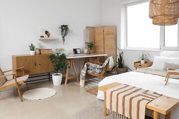 Modern interior of light bedroom with workplace