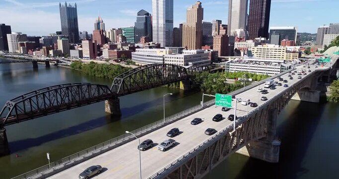 Aerial view of Pittsburgh, Pennsylvania. Daytime with business district and traffic in background. Monongahela River and Liberty Bridge