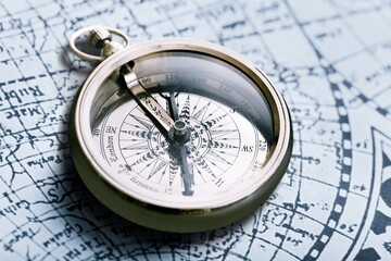 Retro magnetic travel compass on map