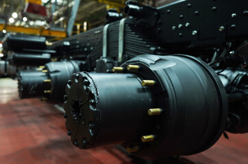 Truck production line. Workshop production of Heavy duty trucks. Trucks Manufacture. Assembly line of truck factory. Heavy duty truck plant. Frame, Wheel chassis, air suspension, air springs. Engine