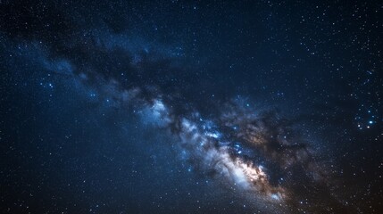 Fototapeta premium A clear night sky filled with twinkling stars, the Milky Way visible in stunning detail as it stretches across the heavens.