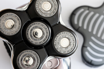 Head shaver on a white background. Macro close-up of the cutting blades. Photo taken in artificial...