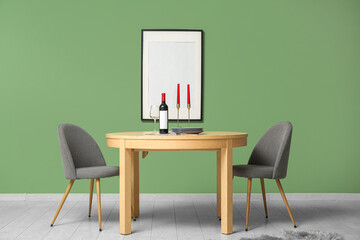 Table with candles and wine in dining room