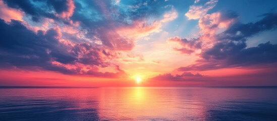 Dramatic sunset over a calm ocean with vibrant pink and blue skies.