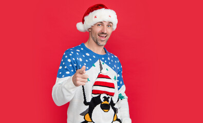 christmas mood. surprised man isolated on red background wear christmas sweater.