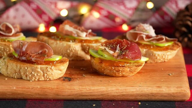 Christmas food, Spanish tapas or Serrano ham pintxos, camera movement from right to left, blurred background