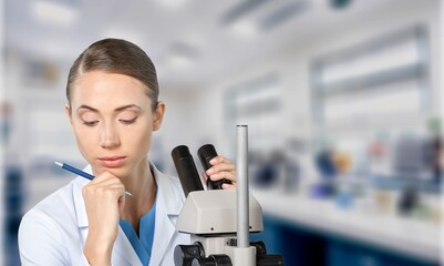 Young smart scientist work with microscope for research