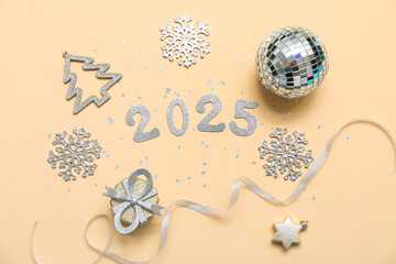 Figure 2025 made of paper, snowflakes, ball and decor on beige background. New Year party. Top view