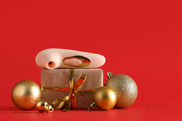 Vibrator, Christmas gift and decorations on red background
