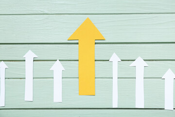 Yellow with white arrows on green background. Coaching concept