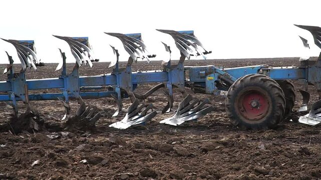 Reversible cultivator. Modern tractor with reversible plow plows the field. Soil cultivation with a cultivator. n