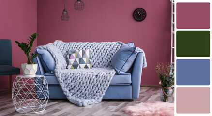 Stylish living room with comfortable sofa near color wall. Interior design and matching color...