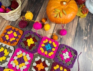 Autumn composition with crocheting, pumpkin, leaves, scissors and clews and hooks fall vibe cozy home photo 
