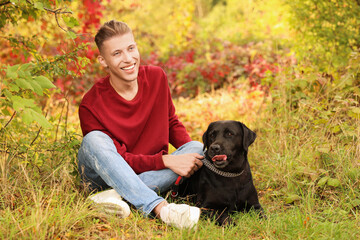 Smiling man with cute dog outdoors on autumn day