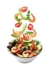 Shrimps and other ingredients falling into bowl on white background
