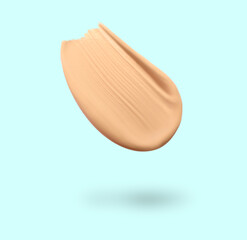 Skin foundation in air on light blue background. Cosmetic product