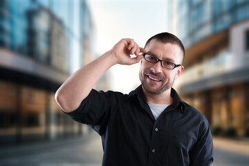 Young businessman posing outdoor at office building.
