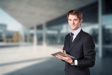 Fototapeta premium Young businessman posing outdoor at office building.