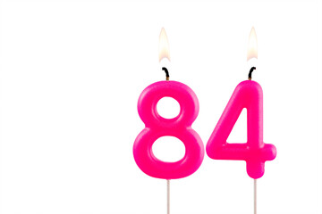 Pink number 84 birthday candle on white background