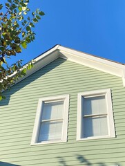 American style architecture. Roof, windows and fronts on blue sky.