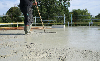 Workers filling the second floor ground with concrete, core and shell construction building 
