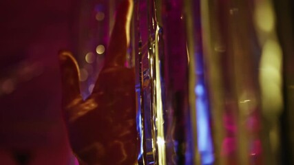 Hands touching shimmering decorations at night party closeup. Woman fingers