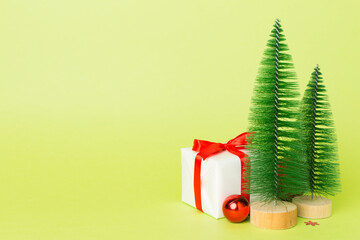 Small christmas trees with decoration on color background