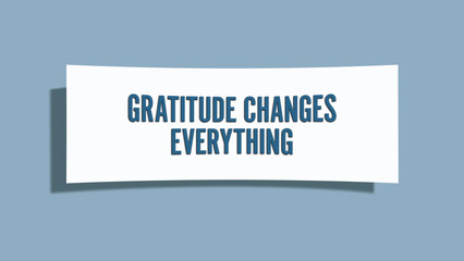 Gratitude Changes Everything. A card isolated on blue background.