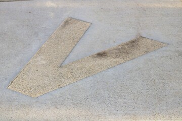 Fototapeta premium letter V on sidewalk at children's school park