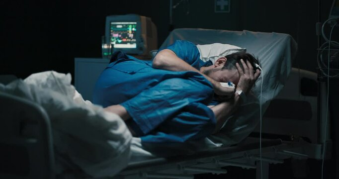 Patient in hospital bed cries loses his temper.