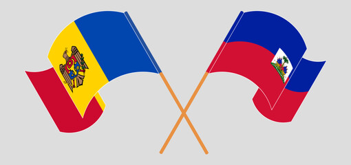 Crossed and waving flags of Moldova and Republic of Haiti. Vector illustration