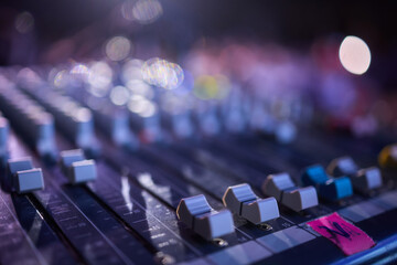 This is a professional audio mixing console that features colorful faders for enhanced usability