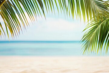 Fototapeta premium Tropical beach scene with palm leaves, sandy shore, and blurred ocean in the background.