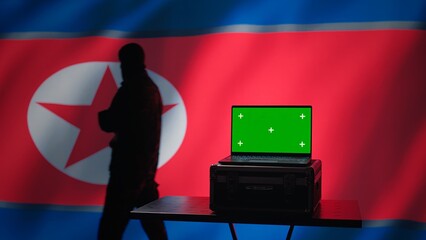 North Korea secret police agent uses mass propaganda tools on green screen laptop to influence...